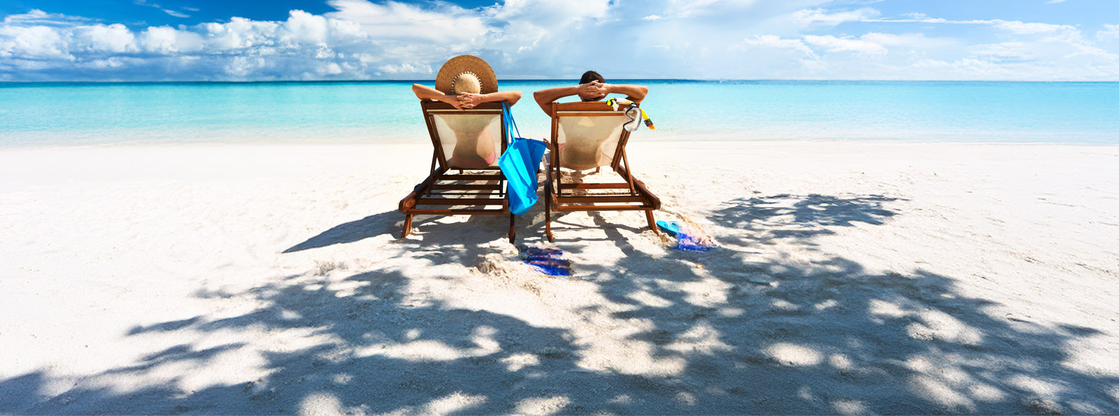 A couple relaxing on the beach as the look out to the water