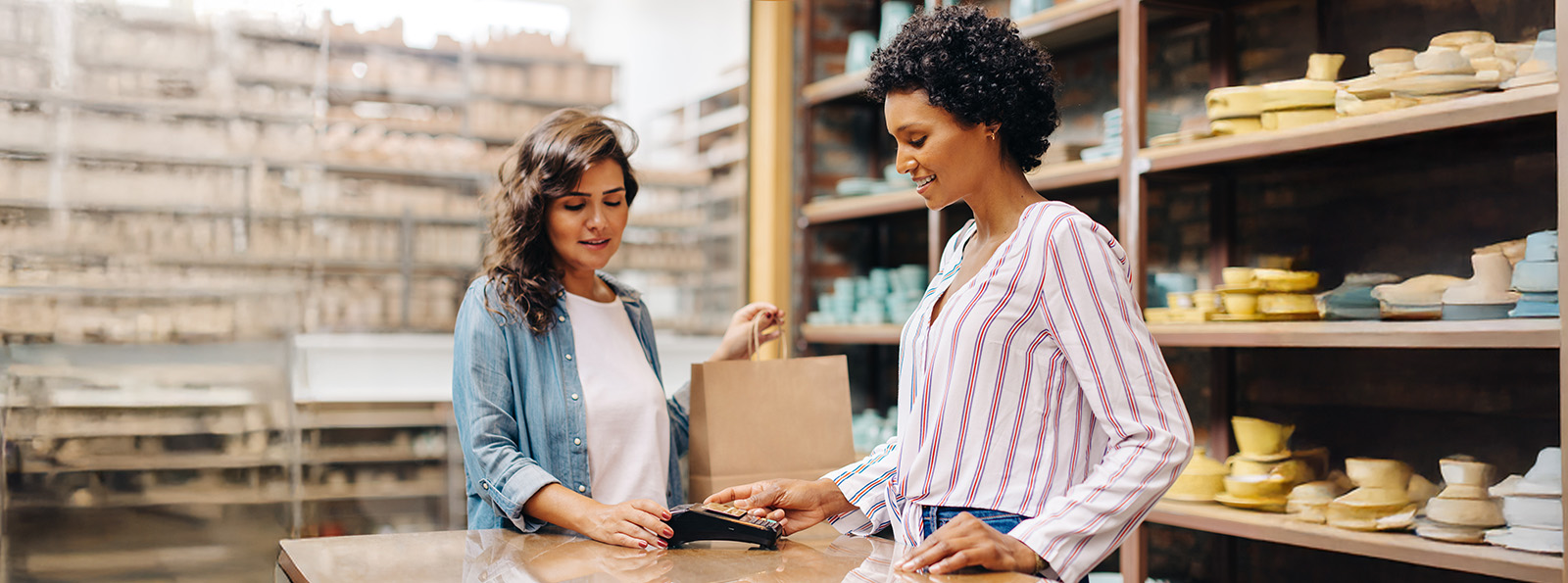 a retail setting with two women at a checkout desk