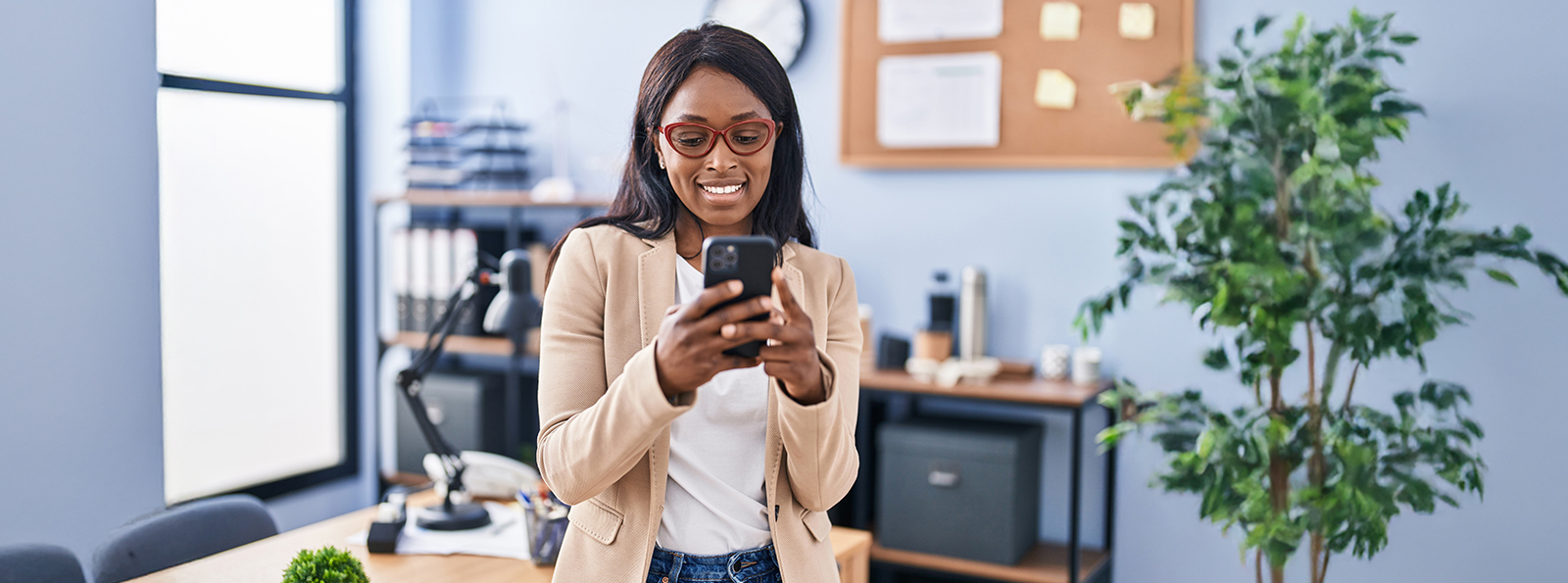 woman with glasses  holding a phone