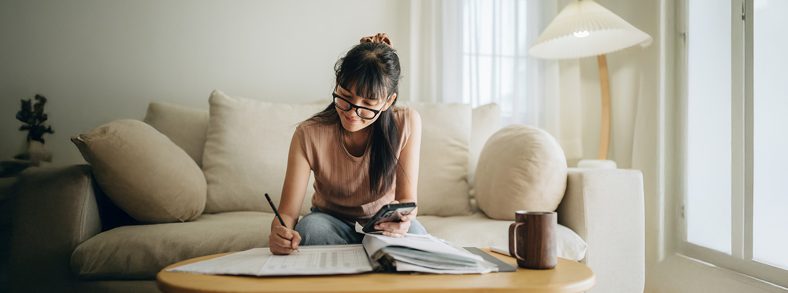 woman using a calculator at home