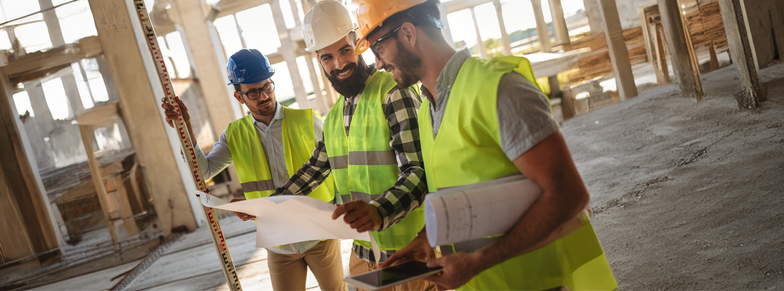 Three construction men on a work site 